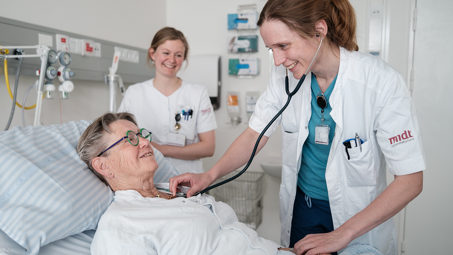 patient talking to doctor in bed